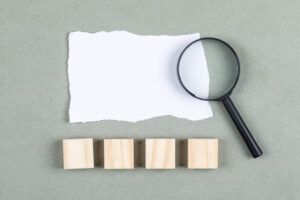 Conceptual of revisiting taken notes hand holding paper. with torn paper on gray background top view. free space for your text horizontal image